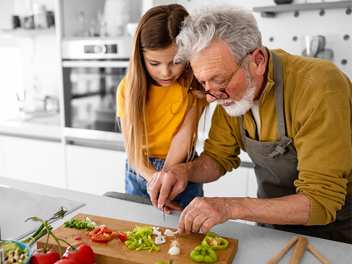 grandfather and granddaughter cooking