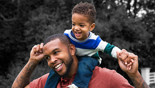 dad giving son piggyback ride