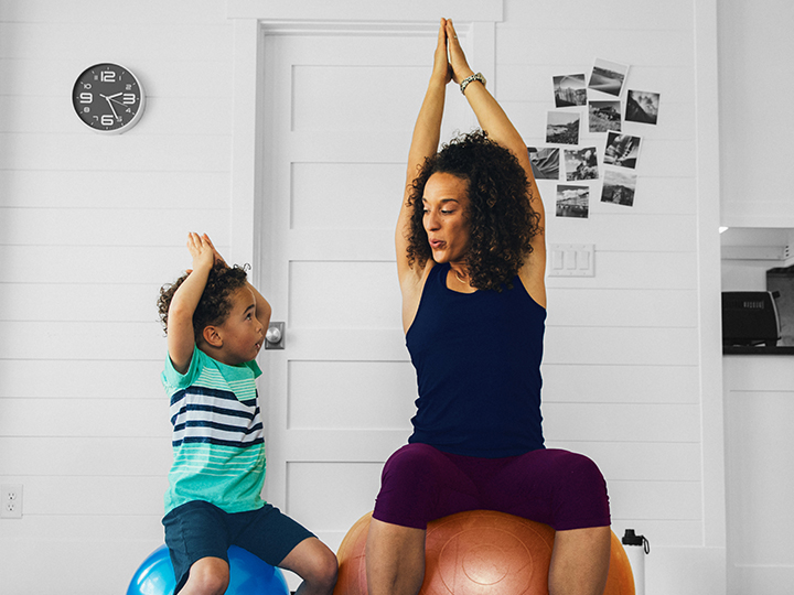 Mother and son exercising using medicine ball