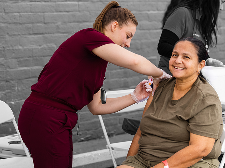 Nurse giving woman a vaccine